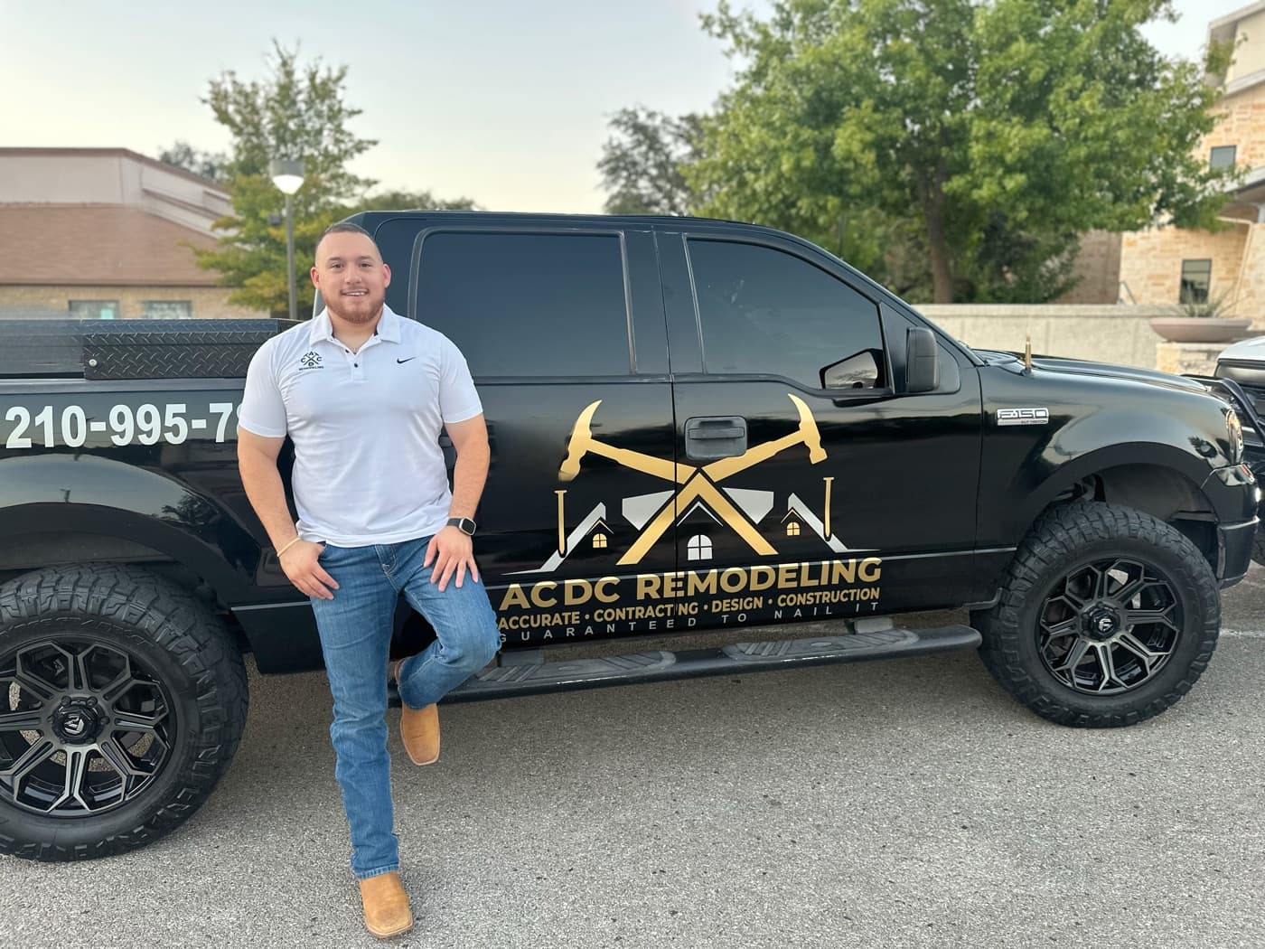 ACDC Remodeling owner standing beside a branded black truck